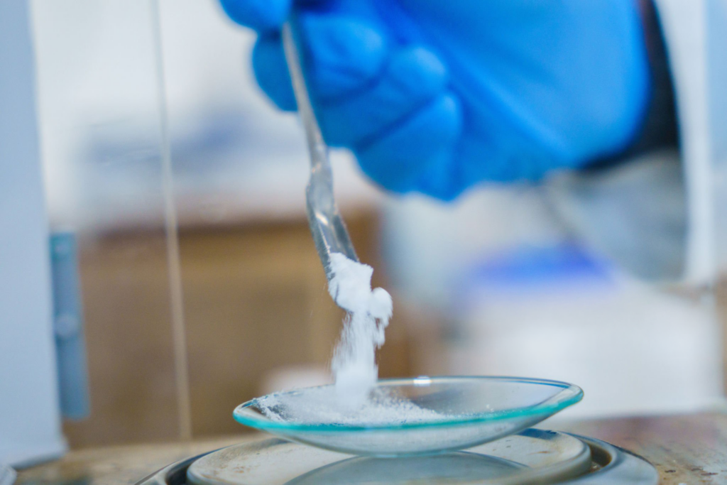 Scientist weighing methanesulfonic anhydride, MSAA